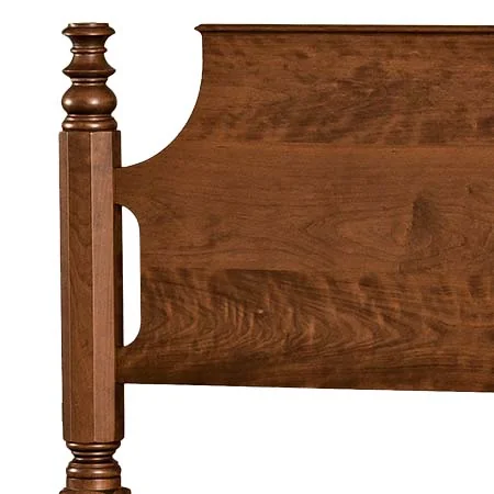 Detail of a turned bed post and shaped headboard
