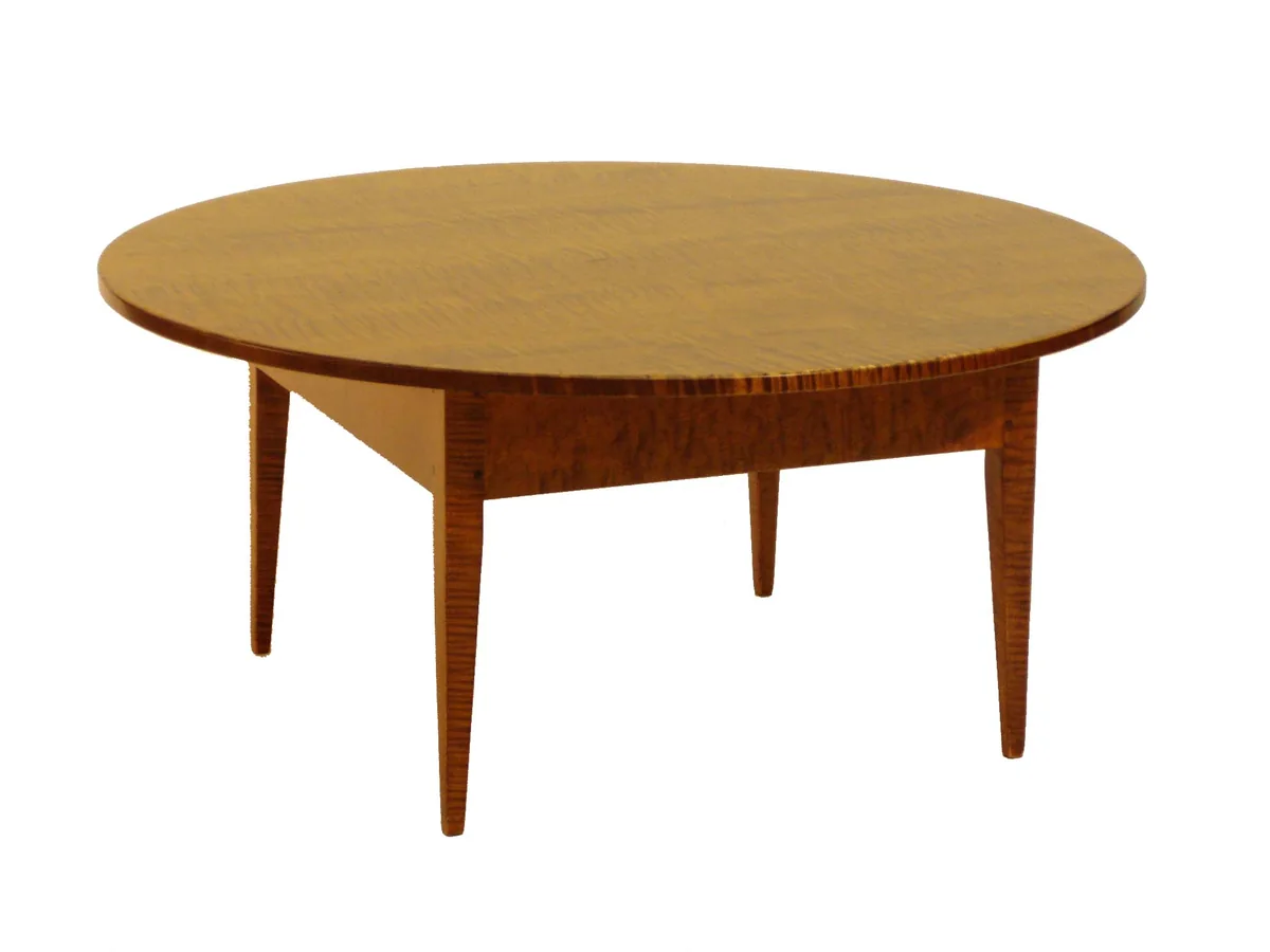 Round coffee table with tapered legs