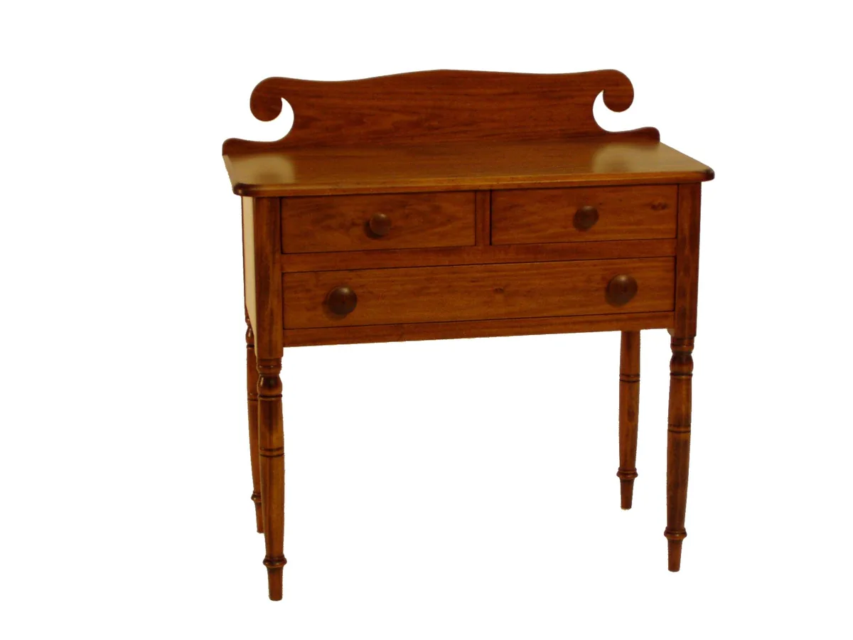 Cherry huntboard with a scrolled backsplash