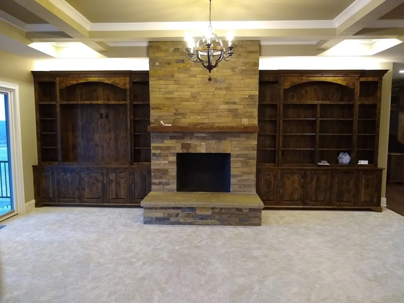 Built-in bookcases flanking a stone fireplace