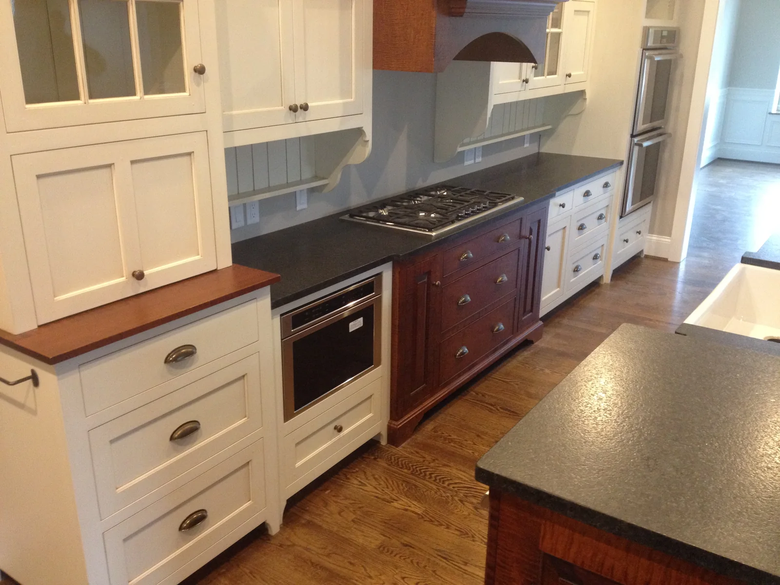 Kitchen with a cherry island set against hand-painted perimeter joinery