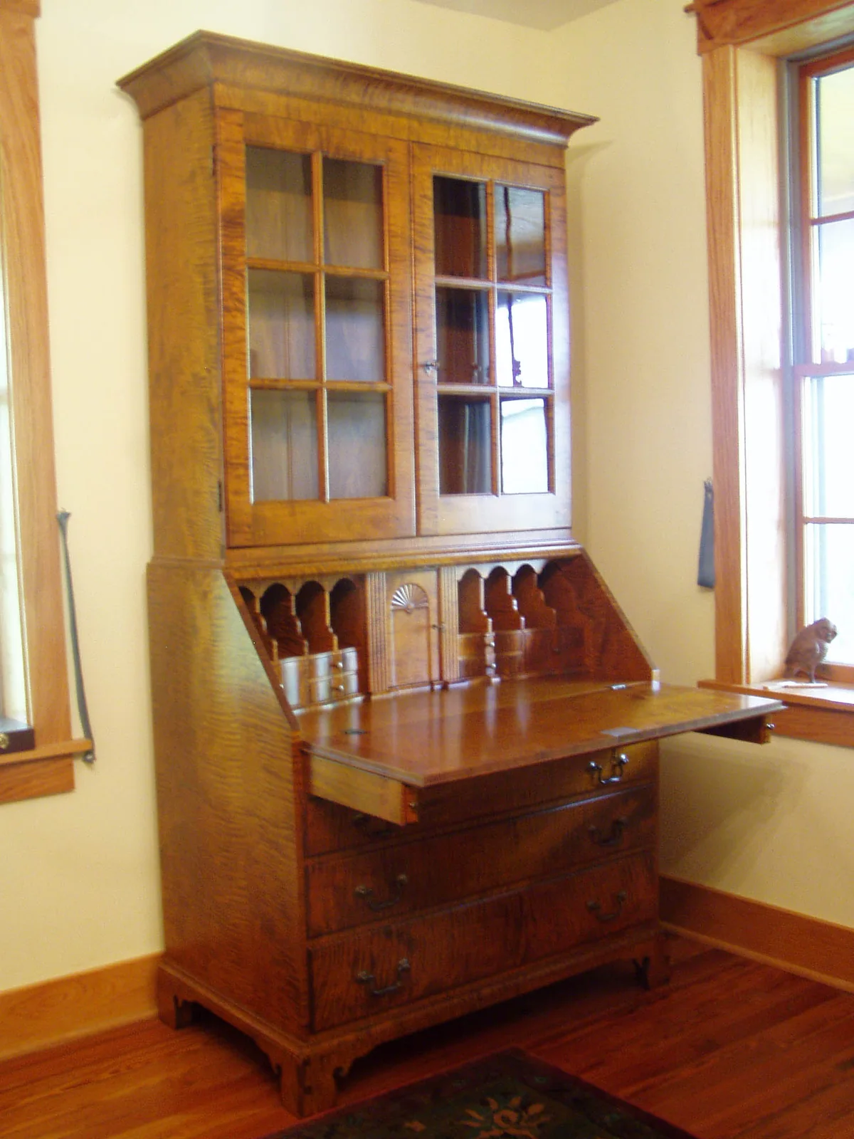 Tiger maple secretary desk with the writing surface open