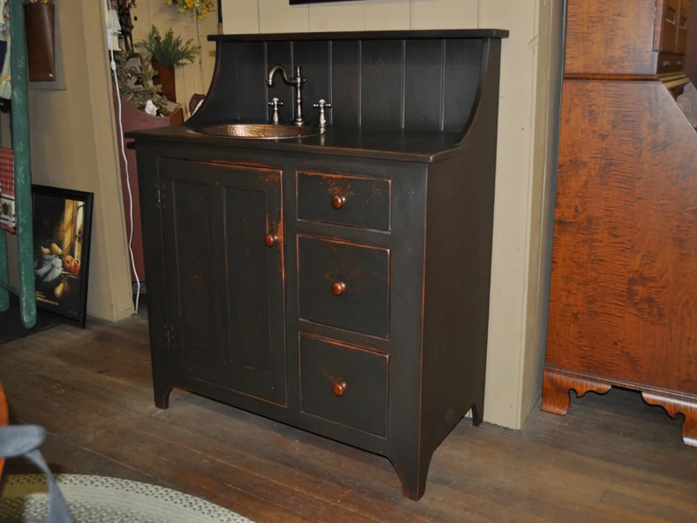 Black painted washstand with a copper basin